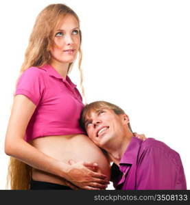 man is listening for baby in stomach of pregnant woman