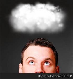 man is looking up at clouds