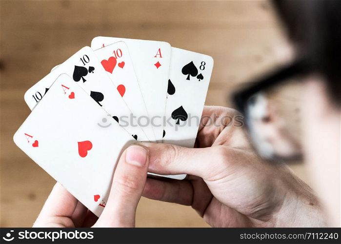 Man is playing cards, cutout of his hands