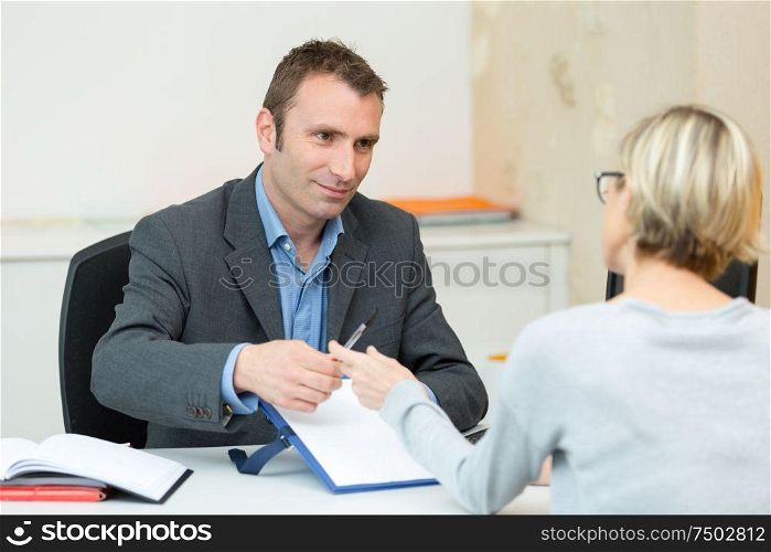 man is showing and offering blank white paper to customer