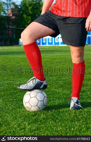 man is standing on football field with ball