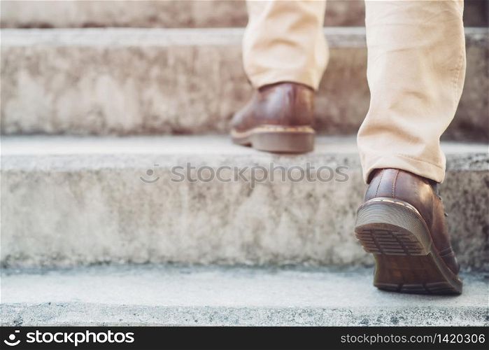 Man is walking up the stairs go to work at the office