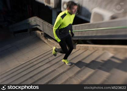 man jogging at cold autumn mornigng on steps