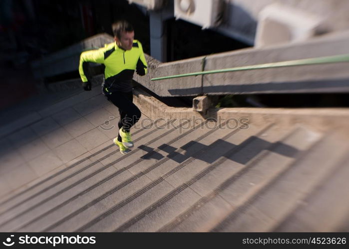 man jogging at cold autumn mornigng on steps