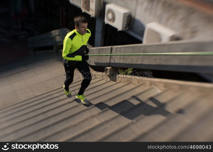 man jogging at cold autumn mornigng on steps