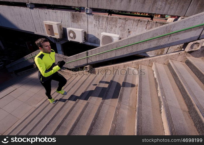 man jogging at cold autumn mornigng on steps