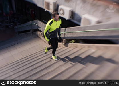 man jogging at cold autumn mornigng on steps