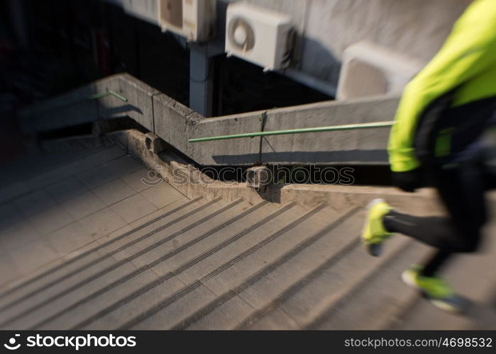 man jogging at cold autumn mornigng on steps