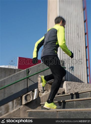 man jogging at cold autumn mornigng on steps