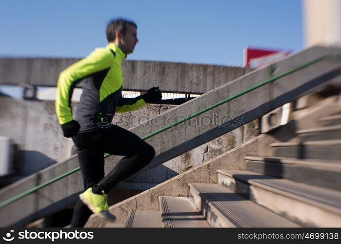 man jogging at cold autumn mornigng on steps