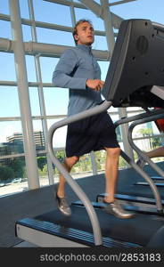 Man Jogging on Treadmill at Gym