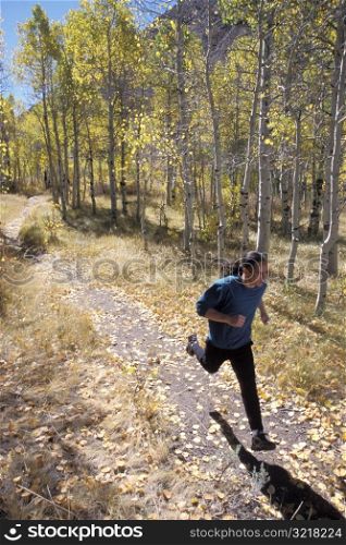 Man Jogging Through Aspen Grove