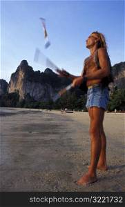 Man Juggling on Beach