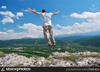 Man jump from mountain. Extreme scene