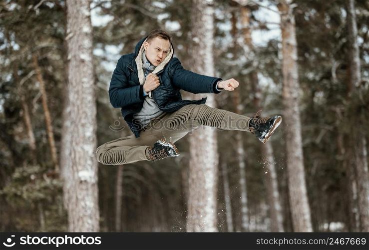 man jumping outdoors nature during winter 2