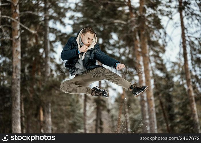 man jumping outdoors nature during winter
