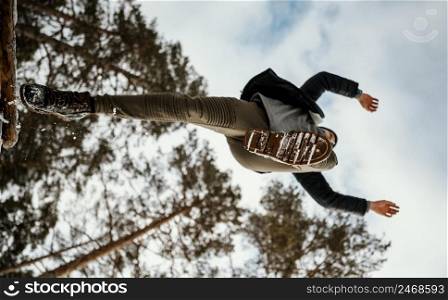 man jumping outdoors nature during winter 3