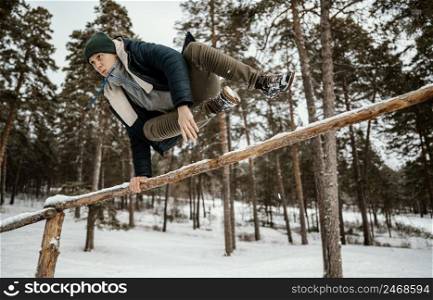 man jumping outdoors winter snow