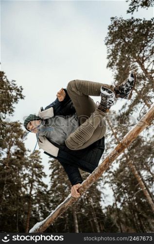 man jumping outdoors winter with snow