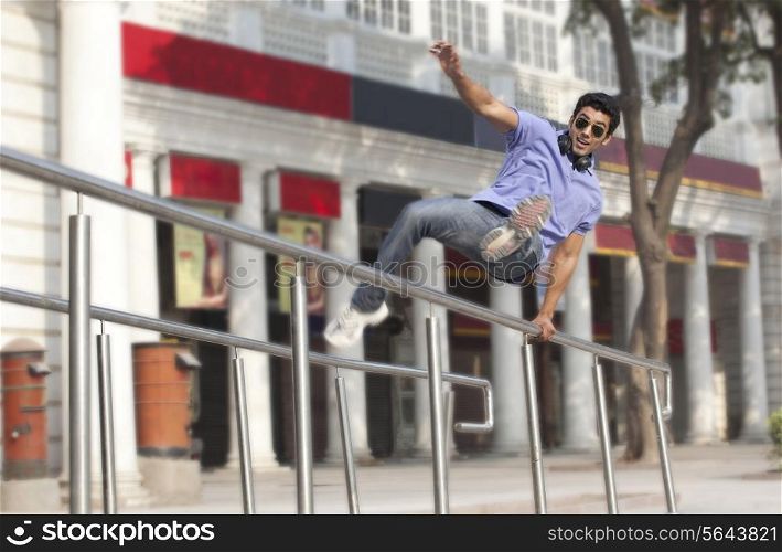 Man jumping over railings