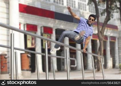 Man jumping over railings