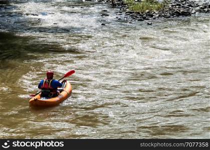 Man kayaking on a river. Outdoor sport. Real people.
