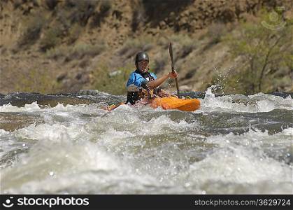 Man kayaking on mountain river