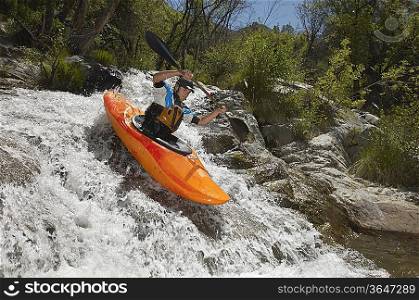 Man kayaking on mountain river