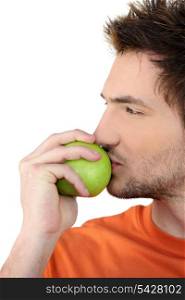 Man kissing a green apple