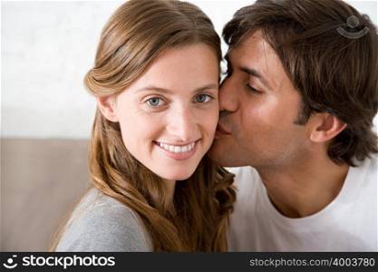 Man kissing a woman on the cheek