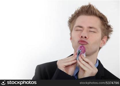Man kissing banknotes