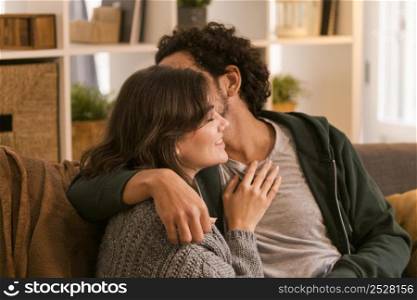 man kissing his wife cheek