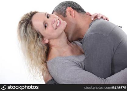 Man kissing wife&rsquo;s neck