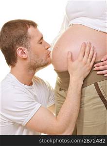 Man kissing woman&acute;s pregnant belly