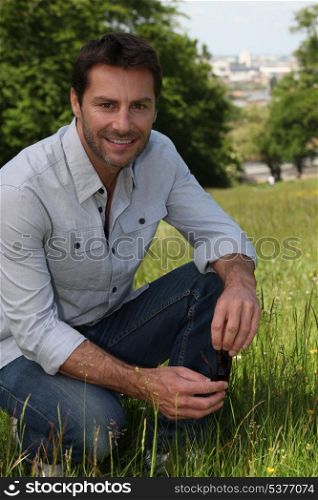 Man kneeling on the grass