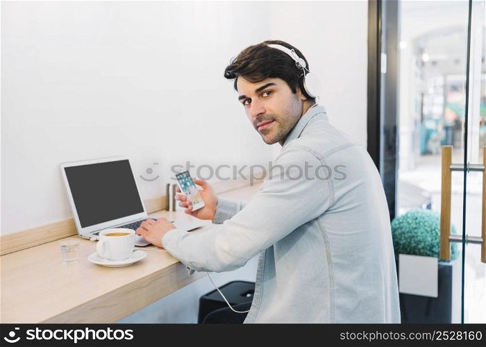 man laptop with smartphone coffee