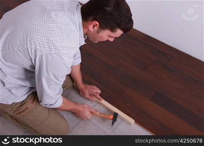 Man laying a hardwood floor