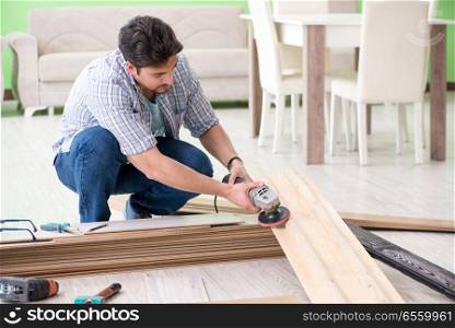 Man laying flooring at home