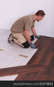 Man laying laminate flooring