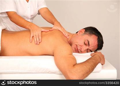 Man laying on massage bed