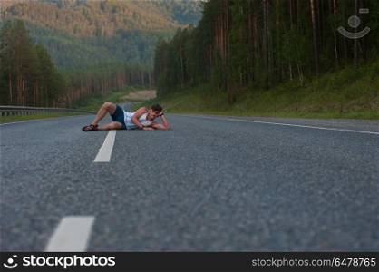 Man laying on the road. Man laying on the beauty road in mountain