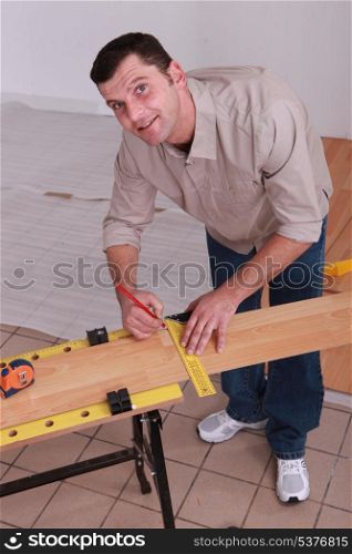 Man laying wooden floor