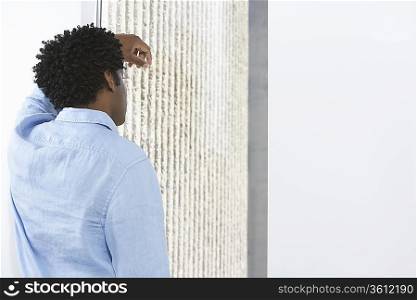 Man Leaning Against Window