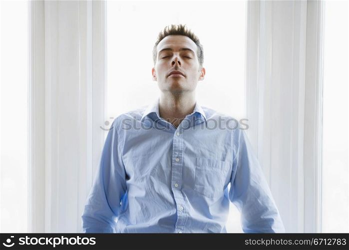 man leaning back on table