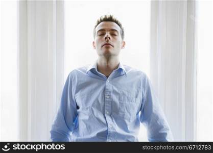 man leaning back on table