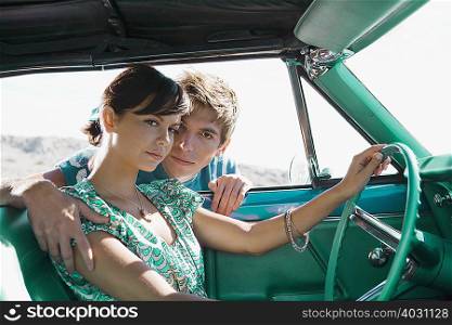 Man leaning into car holding woman