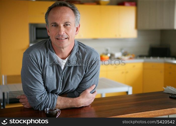 Man leaning on kitchen surface