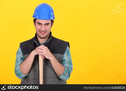 Man leaning on sledge-hammer handle