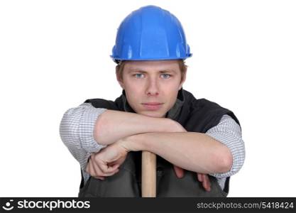 Man leaning on sledge-hammer handle