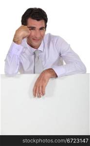 Man leaning on white panel